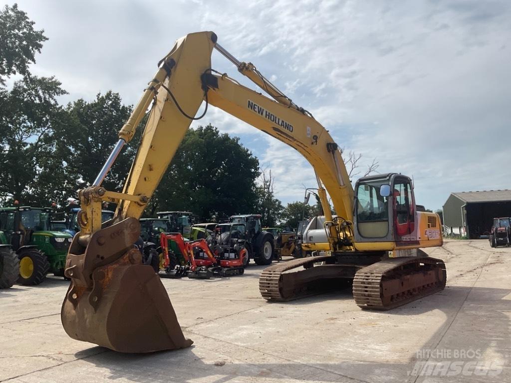 New Holland E 305 Bageri guseničari